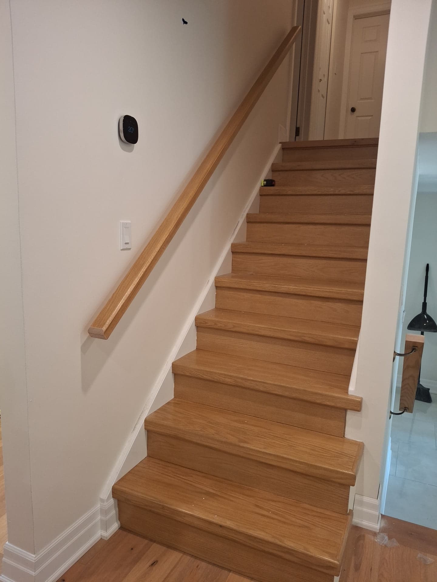Finished wood staircase with matching handrail